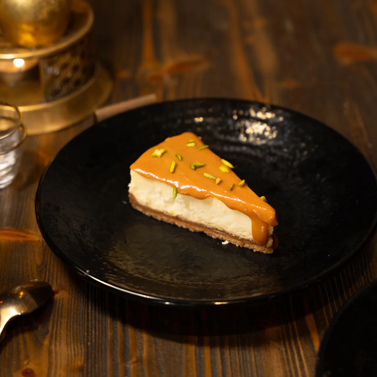 Caramel and burnt sugar cake slice on dark wood